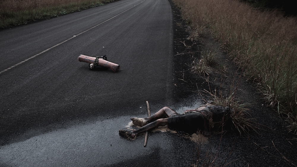 A slaughtered Tutsi woman on the road outside Kigali [Jack Picone/Al Jazeera]