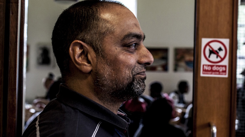 Nasim Ashraf, the chair and founder of UKEFF, welcomes the service's users at the Oldham Unitarian Chapel [David Shaw/Al Jazeera]