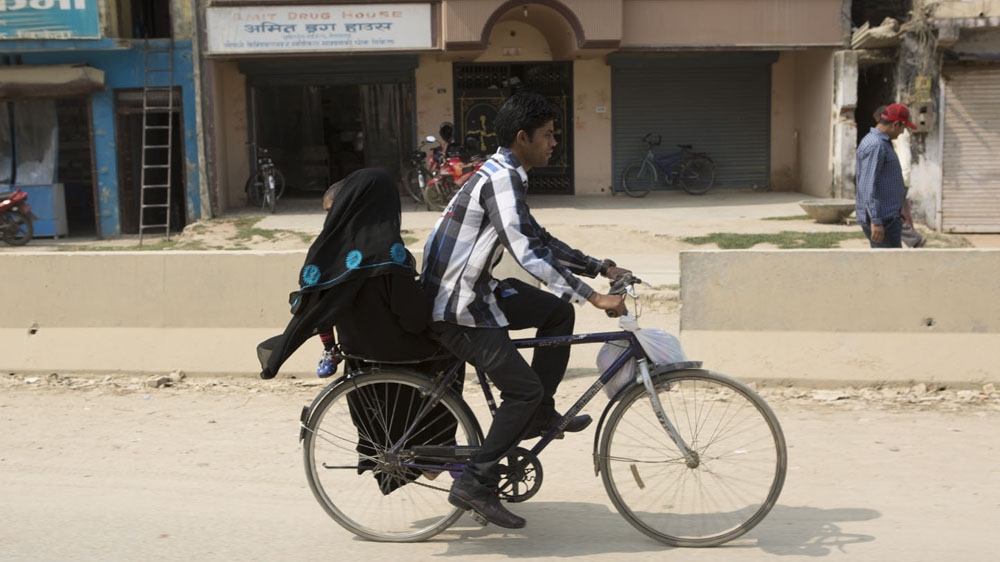 A Muslim couple ride a bicycle in Nepalgunj, in southern Nepal [Prabhat R Jha/Al Jazeera] 