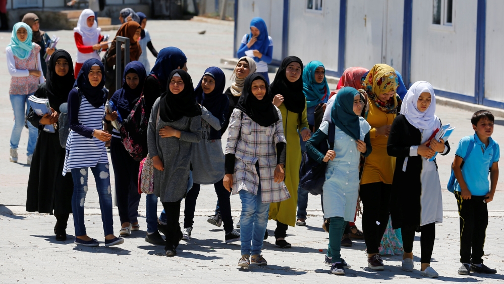 Syrian refugee school children walk to their classes at a refugee camp in Osmaniye