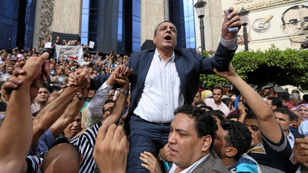 Journalists carry Yehia Kalash, head of the Egyptian press syndicate, during a protest against restrictions on the press and to demand the release of detained journalists
