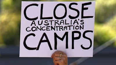 File picture of a protester holding a placard during a rally in support of refugees in central Sydney, Australia