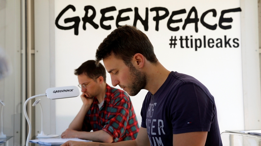 People read copies of the leaked TTIP negotiations inside a public reading room by the environmental campaign group Greenpeace in front of the Brandenburg Gate in Berlin
