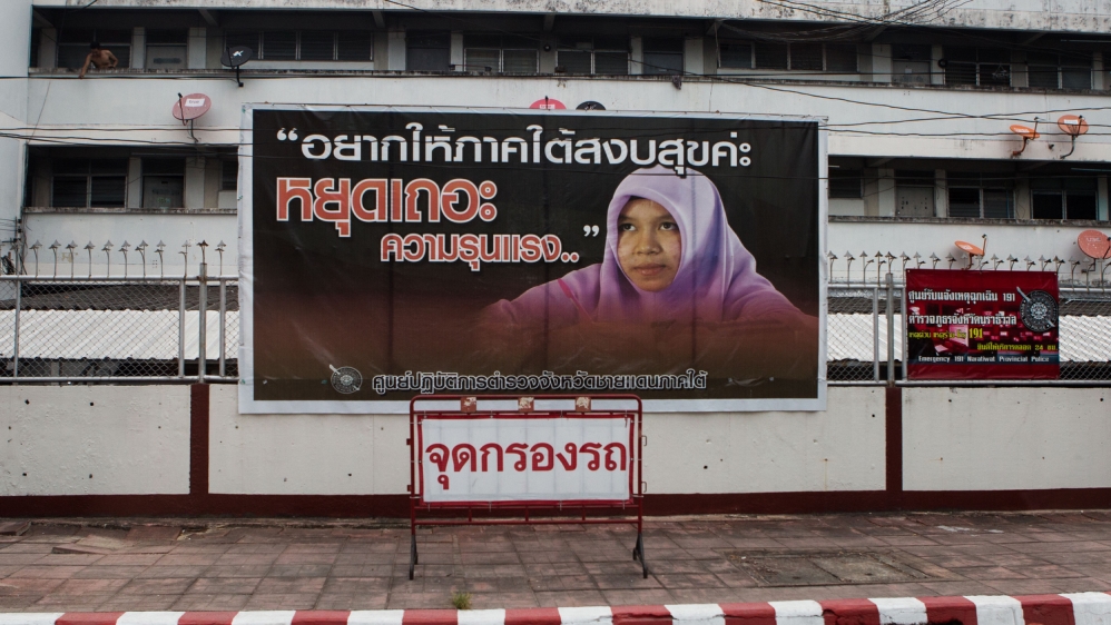 A sign outside of a military checkpoint that states: 'I just want the south to be peaceful; stop already, with all your violence' [Amanda Mustard/Al Jazeera]