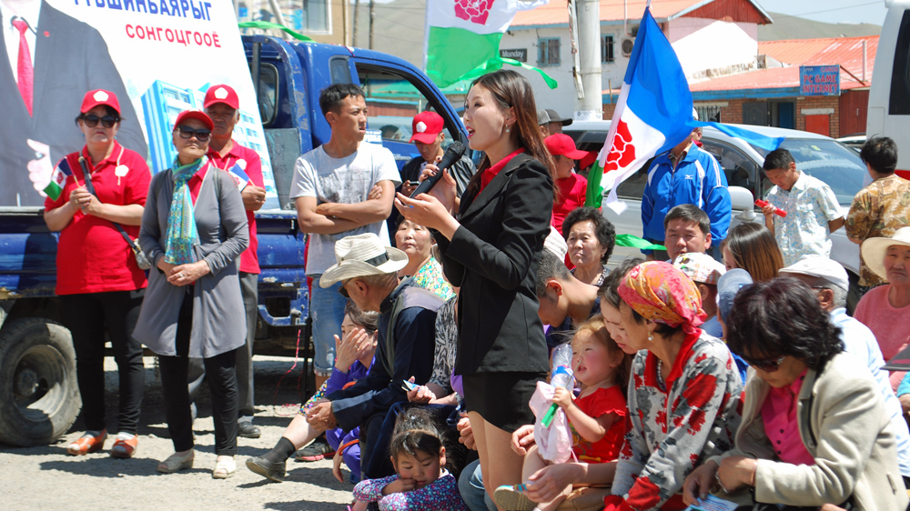 A woman asks a question of candidate Erdenebat Danzan from the Mongolian People’s Revolutionary Party [Ganbat Namjilsangarav/Al Jazeera]