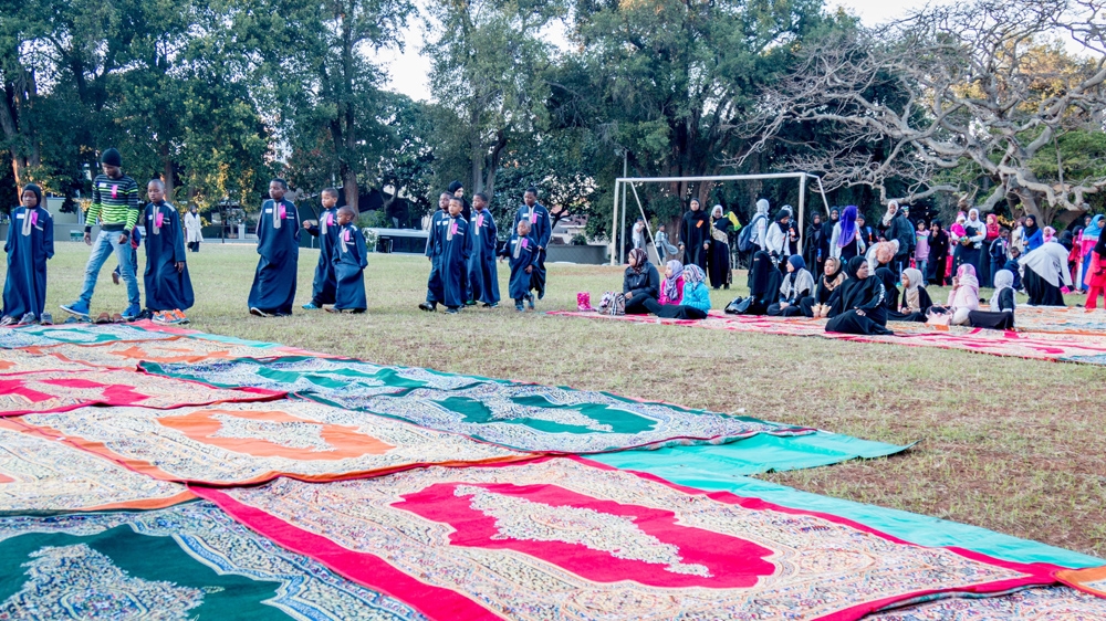 Women and underprivileged children begin assembling for the Eid salaah at an event organised by non-profit organisation ILM-SA in Durban [Fayyaaz Akoob/Al Jazeera] 