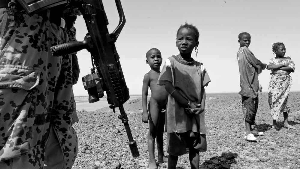 
The peacekeepers talk to children during the patrol [  Marielle van Uitert/Al Jazeera]   
