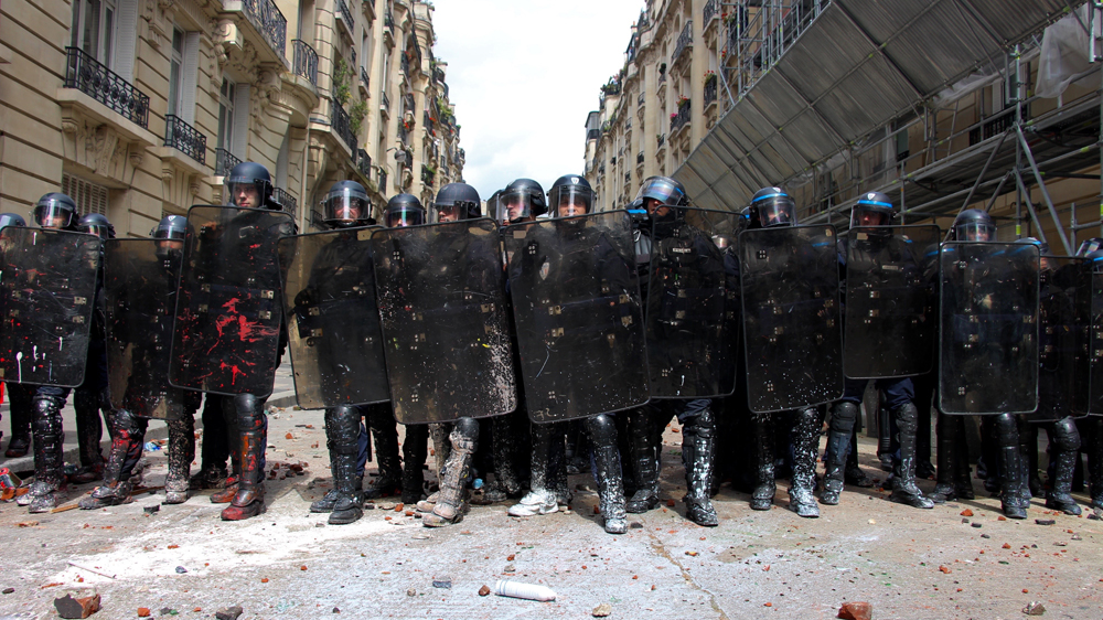 Anti-riot police face demonstrators during an anti-labour law protest in Paris [Paul Fargues/Al Jazeera]
