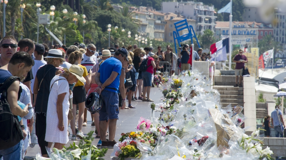 People enjoy the beach on July 17, 2016, in front of the Promenade des Anglais in the French riviera city of Nice three days after deadly attack of the Bastille day.