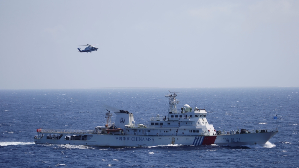 Chinese ship and helicopter are seen during a search and rescue exercise in the South China Sea [Reuters]