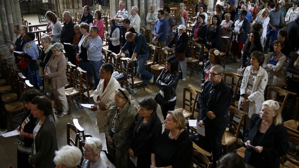 People attend a mass to pay tribute to French priest Father Jacques Hamel at the Cathedral in Rouen in Normandy