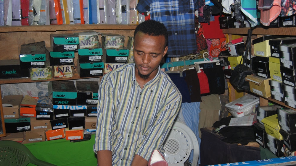 Deck Yusuf Mohamed's family shop was set up by his mother, with the proceeds from selling firewood [Anthony Langat/Al Jazeera] 