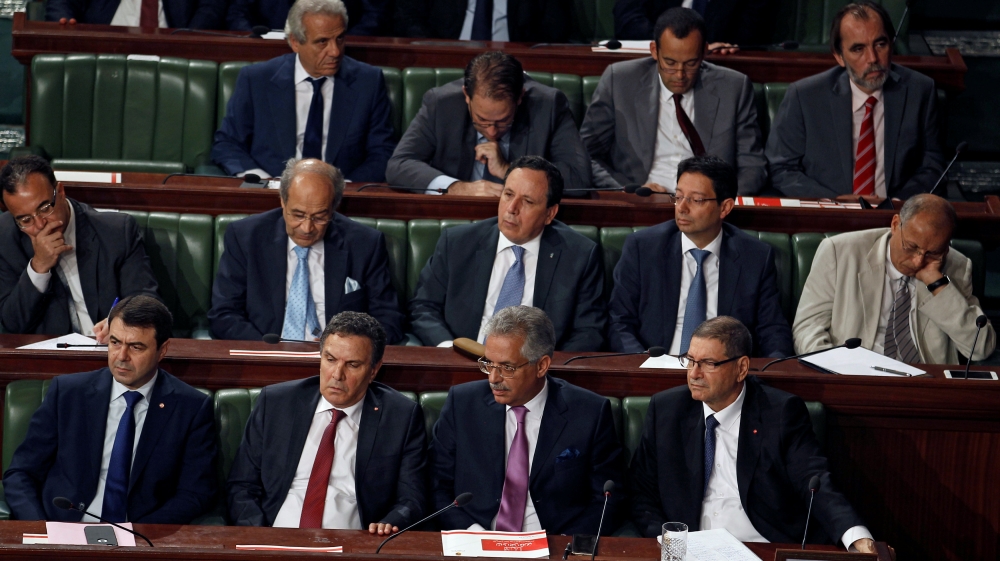 Tunisian Prime Minister Essid, Justice Minister Mansour, Tunisian Defense Minister Horchani and Interior Minister Majdoub attend a plenary session at the Assembly of People''s Representatives in Tunis