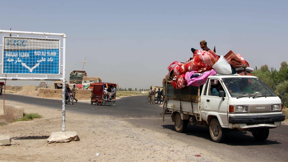Afghan families flee after clashes between Afghan security forces with Taliban [WATAN YAR/EPA]