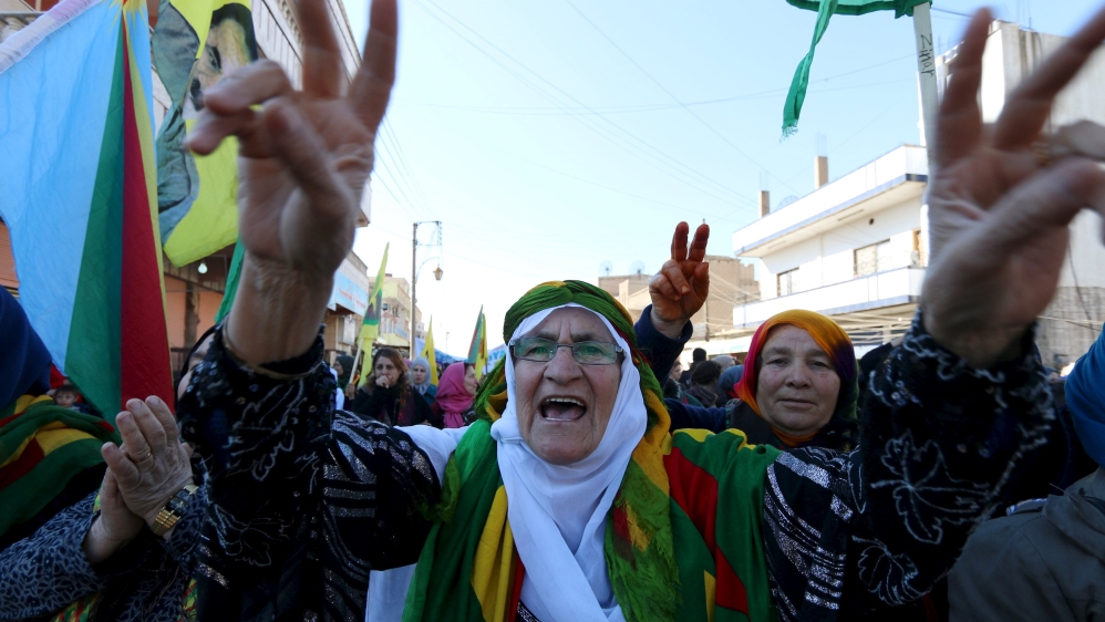 Kurdish women gesture and shout slogans during a demonstration against the exclusion of the Syrian Kurds from the Geneva talks, in the northeast Syrian Kurdish city of Qamishli