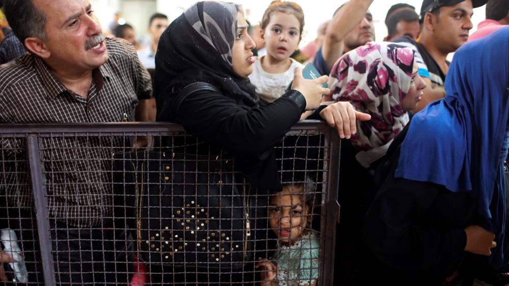 People wait for travel permits to cross into Egypt through the Rafah border crossing after it was opened by Egyptian authorities on Wednesday for five days, in the southern Gaza Strip