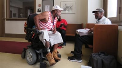 
Scott Lovell, left, says he is a convicted felon in three states and even though he can still vote - he says he won't. 'My vote ain't important,' he says [Jessica Sarhan/Al Jazeera] 
