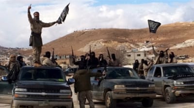 Al-Nusra Front fighters carry weapons on the back of pick-up trucks during the release of Lebanese soldiers and policemen in Arsal, eastern Bekaa Valley, Lebanon [Reuters]