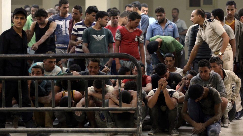 Rescued migrants from a boat that capsized in the Mediterranean Sea are pictured in Al-Beheira
