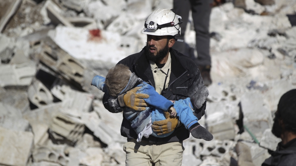 Syria Civil Defence caries child after air strike in Idlib