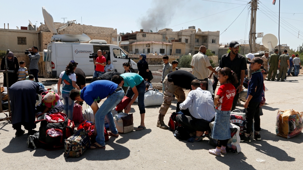 In the next stage of the Moadamiyeh deal, rebels who refuse to hand over their weapons will be forced to leave to rebel-held areas in northern Syria [Reuters]