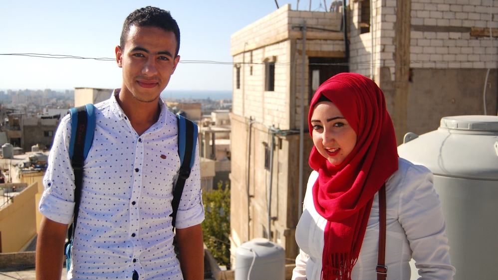 Mustapha Dakhloul, left, and Amal Said on a rooftop in Burj al-Shamali, one of the spots from which they flew a balloon over the camp [Jillian Kestler-D'Amours/Al Jazeera]