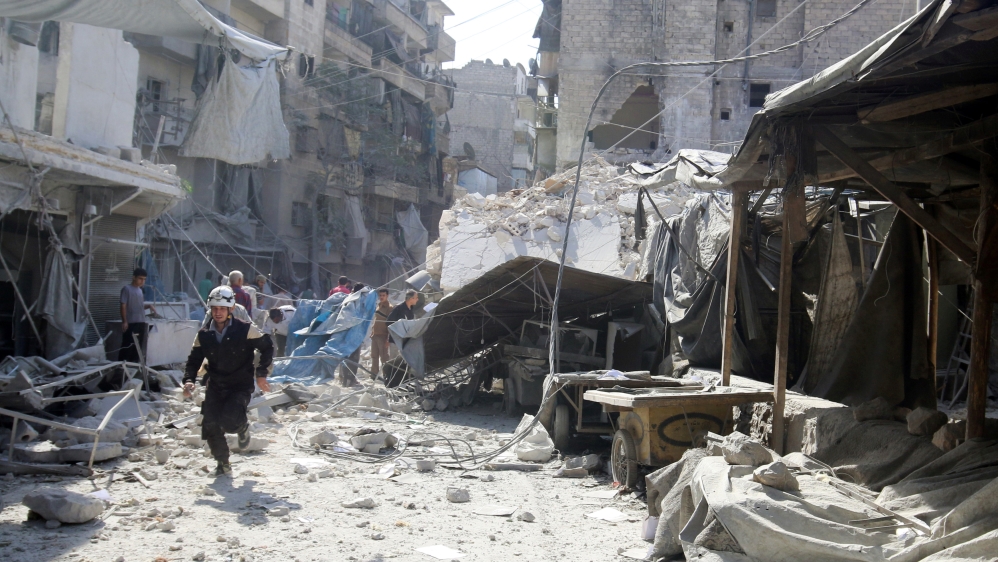 A civil defence member runs at a market hit by air strikes in Aleppo''s rebel-held al-Fardous district, Syria [REUTERS]