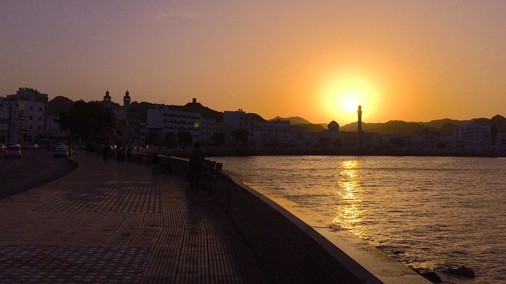 Masjid al-Rasool al-Adham, or the Mosque of the Great Prophet, is silhouetted against the setting sun in Muscat [Baba Umar/Al Jazeera]