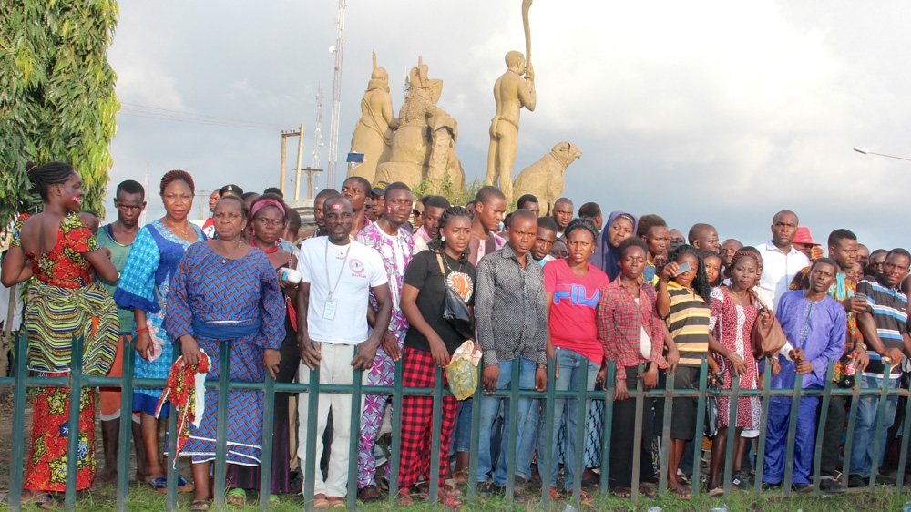 The Oba's subjects wait outside the coronation hall to see their new king [Femke van Zeijil/Al Jazeera] 