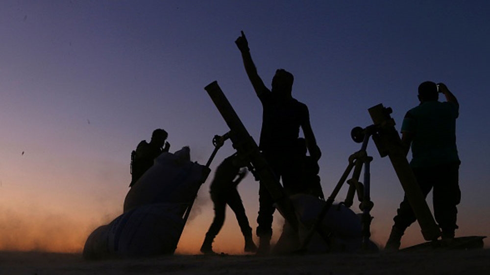 FSA fighters cheer and react as they fight against ISIL on the outskirts of the northern Syrian town of Dabiq [Getty]