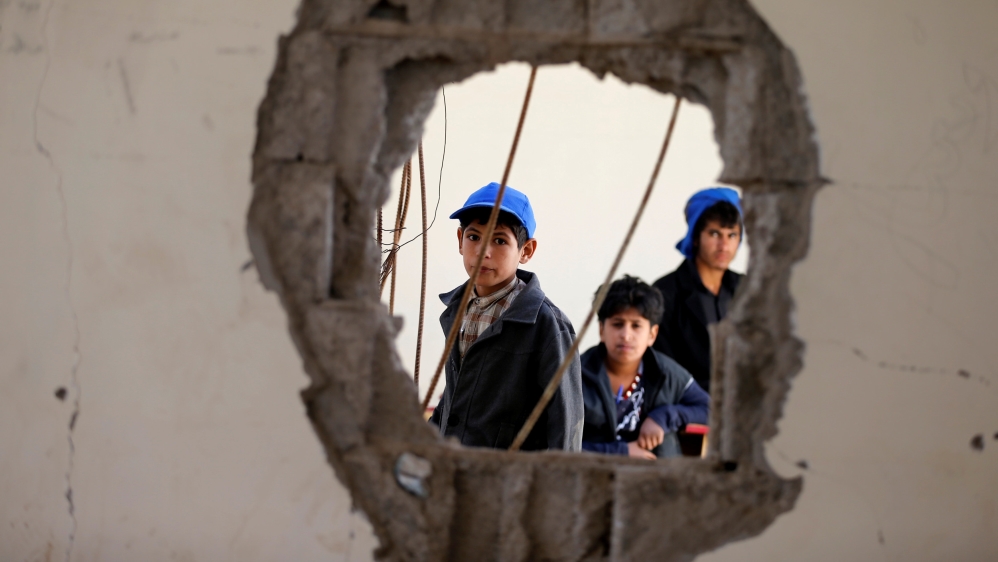 Boys look as they sit in a damaged class of their school which was hit by Saudi-led air strikes last year, as schools open this week in Sanaa, the capital of war-torn Yemen