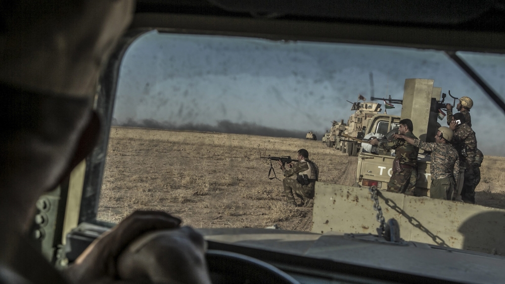 Peshmerga forces shoot during an operation to liberate several villages currently under the control of ISIL southeast of Mosul, Iraq [EPA]