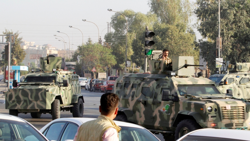 Military vehicles of peshmerga forces are seen at a site of an attack by Islamic State militants in Kirkuk