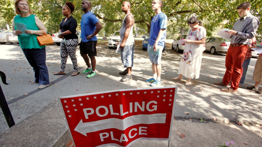 People arrive to cast their ballot for 2016 elections at a polling station as early voting begins in North Carolina, in Carrboro, North Carolina