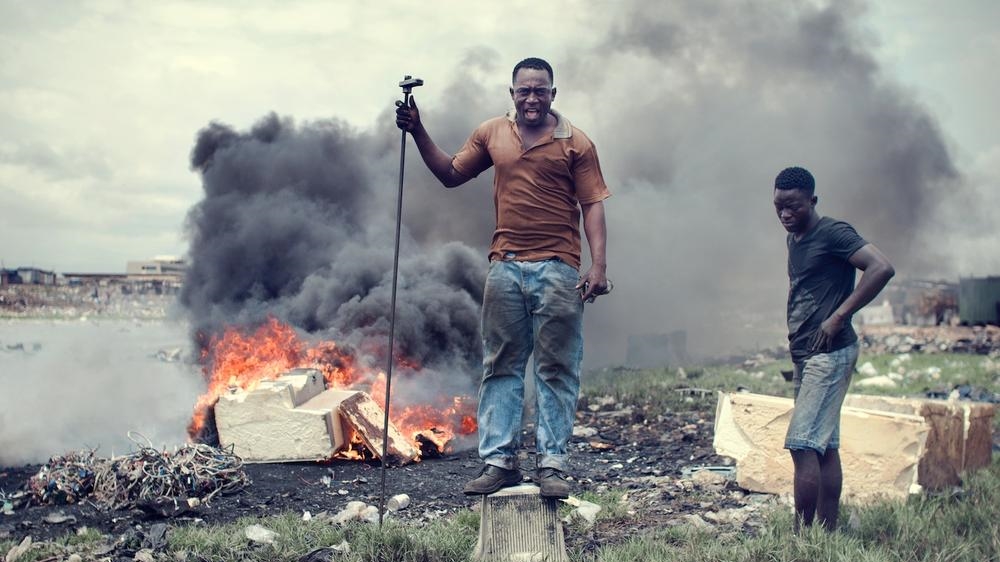 Agbogbloshie is the world's biggest e-waste dumpsite and is located near Accra, Ghana. Electronic waste - TVs, PCs, hi-fi systems, refrigerators - defines the landscape of this former wetland and recreation area.  Here in Agbogbloshie, boys and men aged between seven and 25 smash stones and simple tools against TVs and PCs to get to the metals, particularly the copper. They will earn about $2.50 for a day's work. Most of them left families in the impoverished northern and upper west regions of Ghana when they came to work here. [Kevin McElvaney/Al Jazeera]