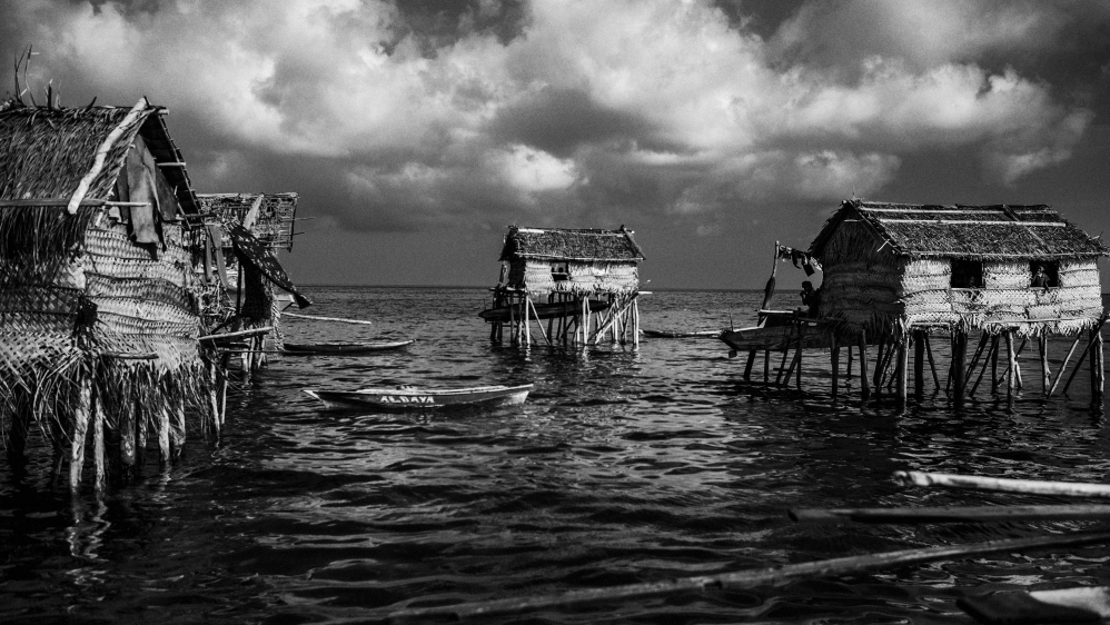 The Badjao are a sea-dwelling tribe, often known as the 'Sea Nomads', who have been floating off the shores of Southeast Asia for centuries. As a nomadic tribe living in stilt huts or boat houses on shallow waters, they make their living from traditional free-diving for fish and pearls.  As they belong to no official state and possess no official nationality, they find the move from sea to land a challenge. Because of their nomadic lifestyle, the Badjao are at a disadvantage with no schooling, healthcare or access to government-provided social services. [Guillem Valle/Al Jazeera]