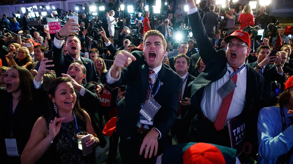 Supporters of Republican presidential candidate Donald Trump cheer as they watch election returns during an election night rally [The Associated Press]