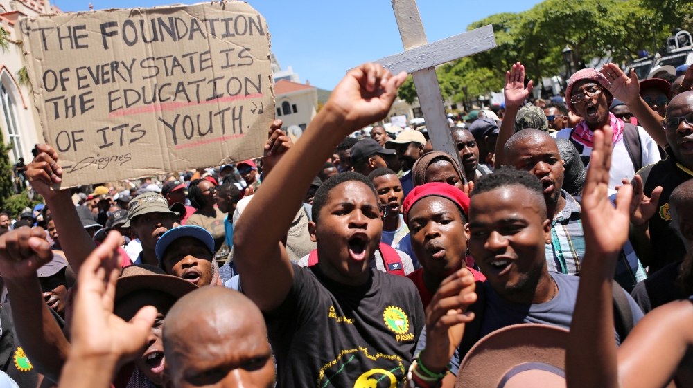 Students protest outside the parliament ahead of South African Finance Minister Pravin Gordhan''s medium term budget speech in Cape Town