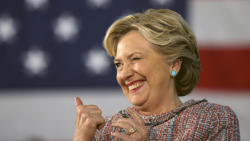 U.S. Democratic presidential nominee Hillary Clinton winks at a supporter as she talks about climate change at a rally at Miami Dade College with former Vice President Al Gore in Miami