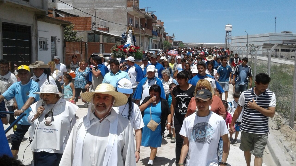 Community members in Villa 21 march on December 8 to name their public plaza - where Elida del Valle Barrios was killed - in honour of the Virgin Mary, who is believed to protect women [Courtesy of Miguel Sergio Leiva ]