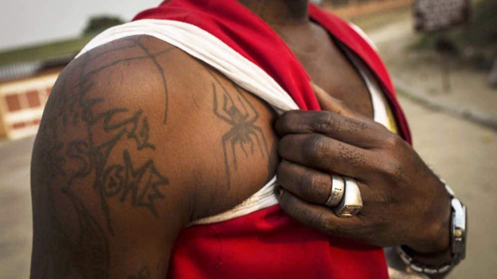 Kris Bitenda shows off the tattoos that adorn all parts of his body [Francesca Volpi/Al Jazeera]