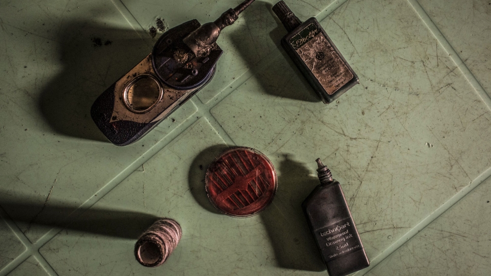  Tattoo utensils, needles, ink, a little motor and string, used by Herve, 25, to draw tattoos [Francesca Volpi/Al Jazeera]