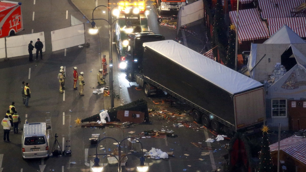 
A tow lorry operates at the scene where a truck ploughed through a crowd at a Christmas market [Fabrizio Bensch/Reuters]
