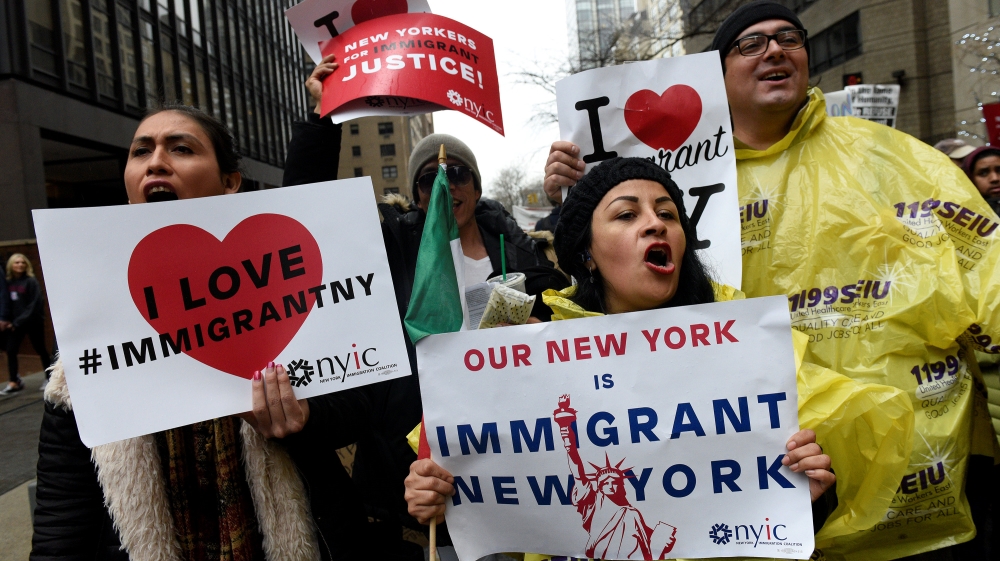 People march towards Trump Tower during a protest organized by the New York Immigration Coalition against President-elect Donald Trump in the Manhattan borough of New York