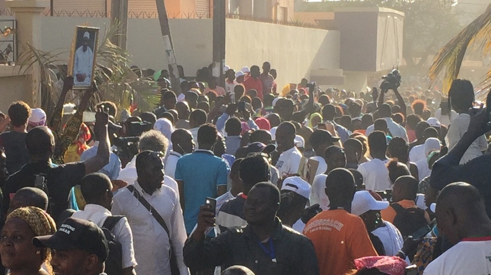 Hundreds of people gathered outside Gambia's embassy in Dakar [Emma Farge/Reuters]