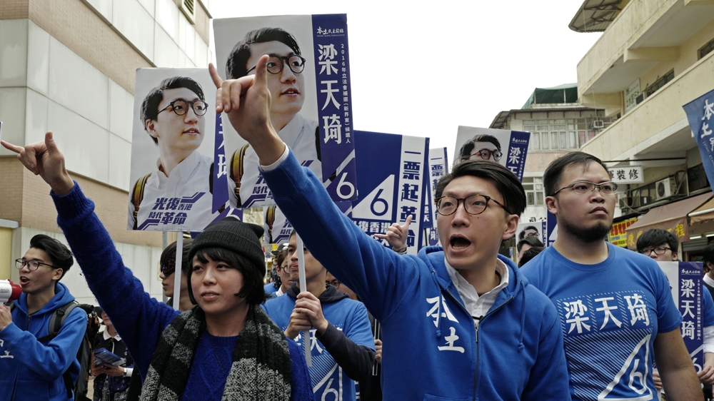 Edward Leung, centre, a candidate of Hong Kong Indigenous, waves to supporters at an election campaign in February 2016 [Vincent Yu/Daylife]