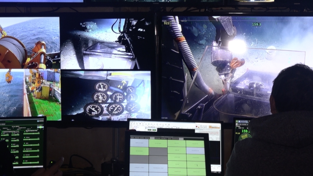 A four-man team drive the submarine from a purpose-built control room inside a shipping container on deck [Tarek Bazley/Al Jazeera]