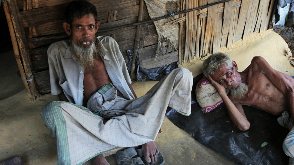 
Rohingya Muslim men sit in their home at an unauthorised camp that houses Rohingya Muslim refugees who fled Myanmar during an ethnic strife in 1992 [Saurabh Das/AP]
