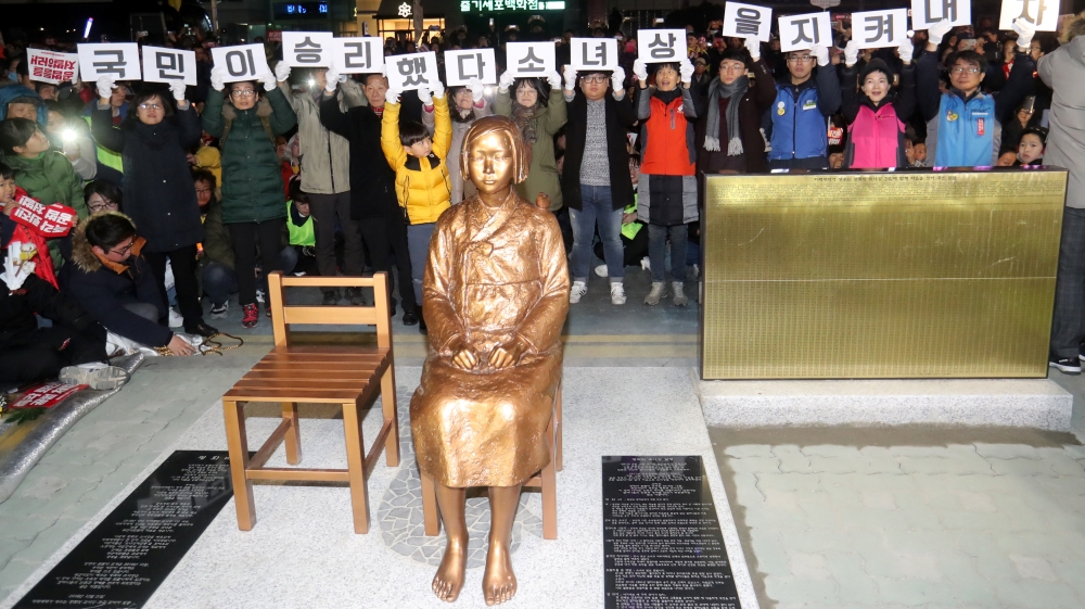 A statue of a girl that represents the sexual victims by the Japanese military is seen during a rally in front of Japanese Consulate in Busan