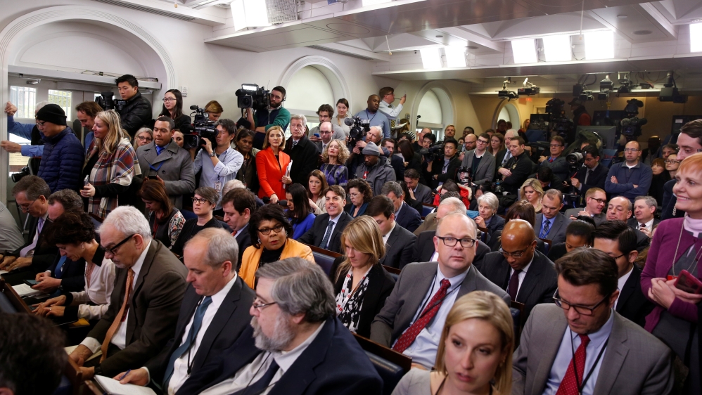 Journalists wait for U.S. President Barack Obama to start his annual year-end news conference